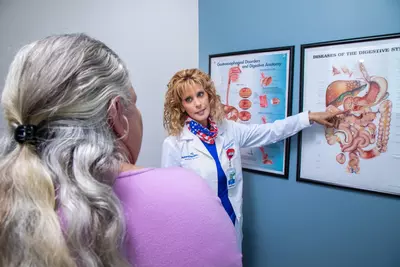 Dr. Sharona Ross explaining digestive track diagram to a patient