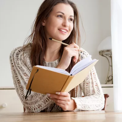 A woman writes in her journal.