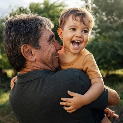 A grandfather holding his grandson.