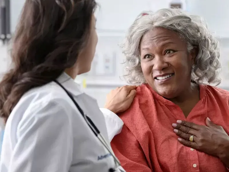 a patient woman talks to a doctor