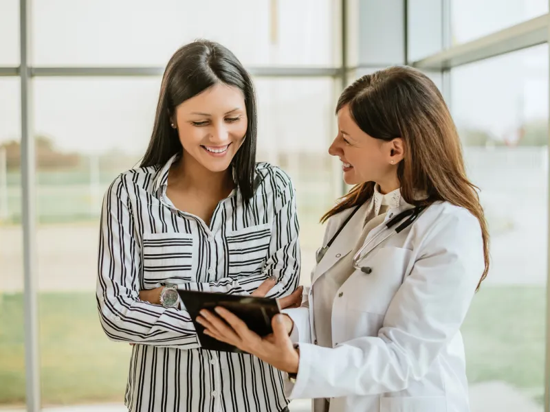 Physician showing information to patient