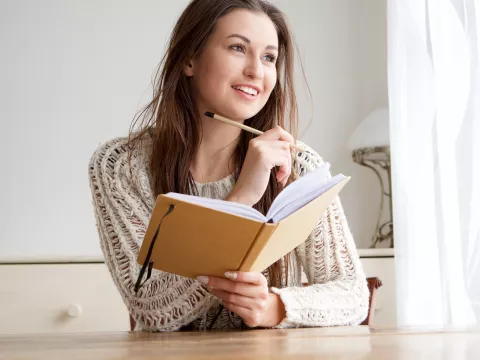 A woman writes in her journal.