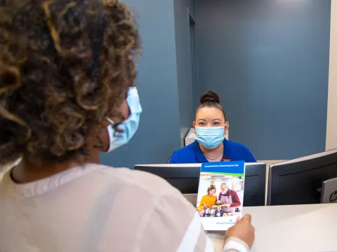 Front desk team member of AdventHealth Digestive Health Institute talking with patient.