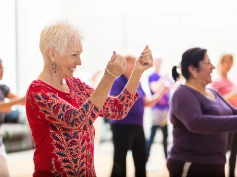 A group of older adults taking a dancing class.