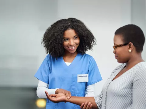 Nurse checking a patient's pulse