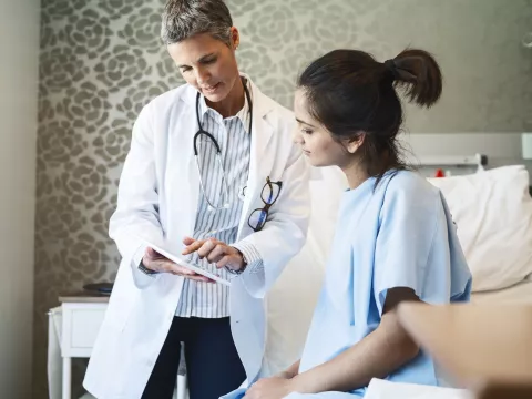 A woman reviews her test results with her doctor.