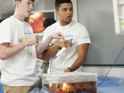 Two young men with AdventHealth shirts.