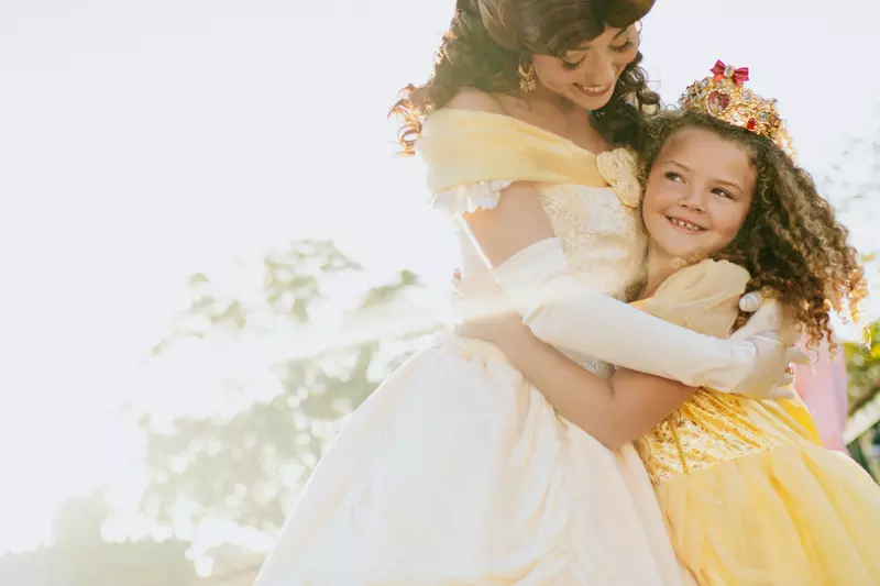 A Child at Walt Disney World Hugs the Disney Princess Belle