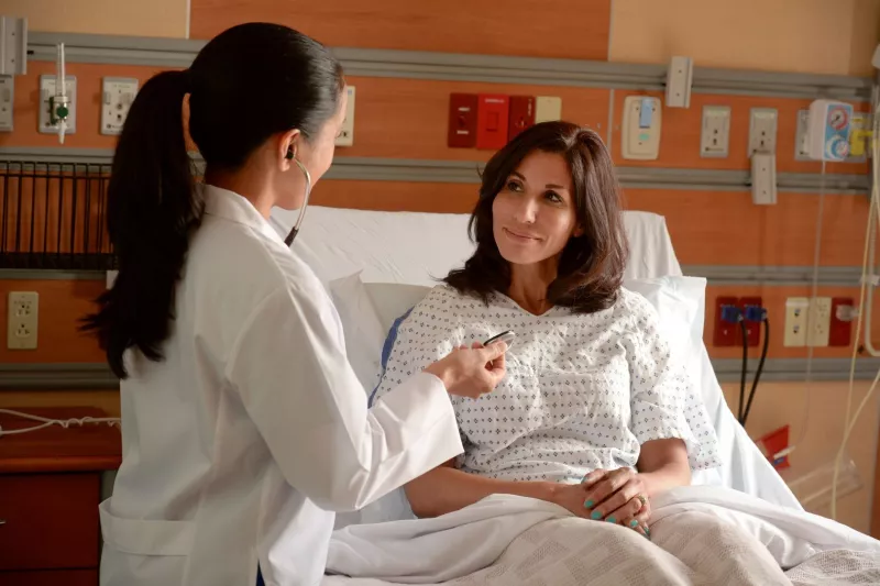 female patient in hospital bed
