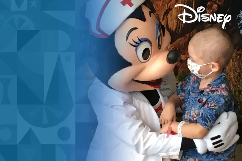 Minnie Mouse dressed a nurse with a child patient wearing a mask