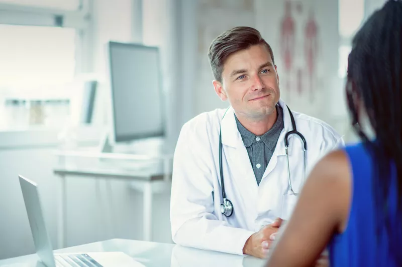 Doctor sitting at a table with a patient