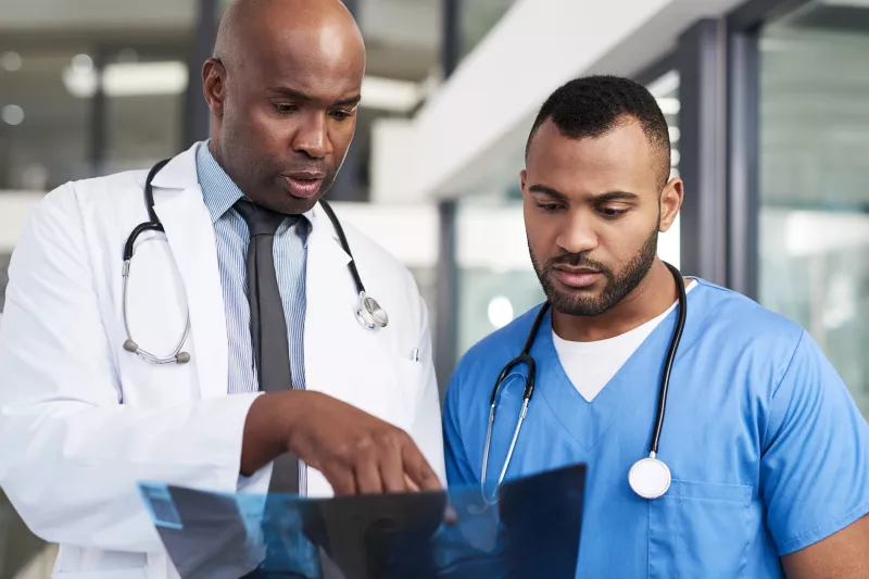 Two medical staff review an Xray.