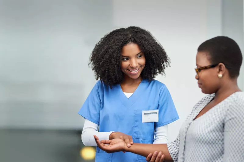 Nurse checking a patient's pulse