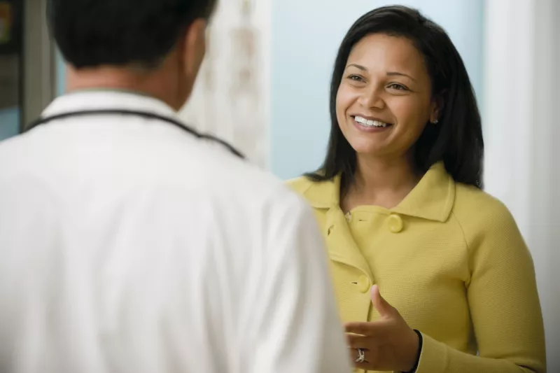 A woman talking to her doctor at a visit.