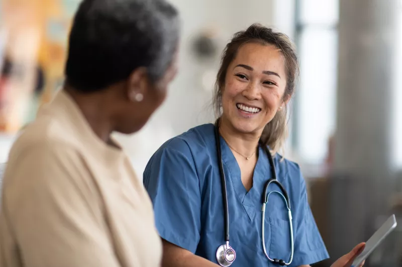 A woman talks with her doctor about her test results.