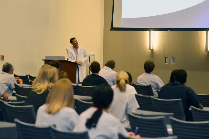 Man speaking at a conference.