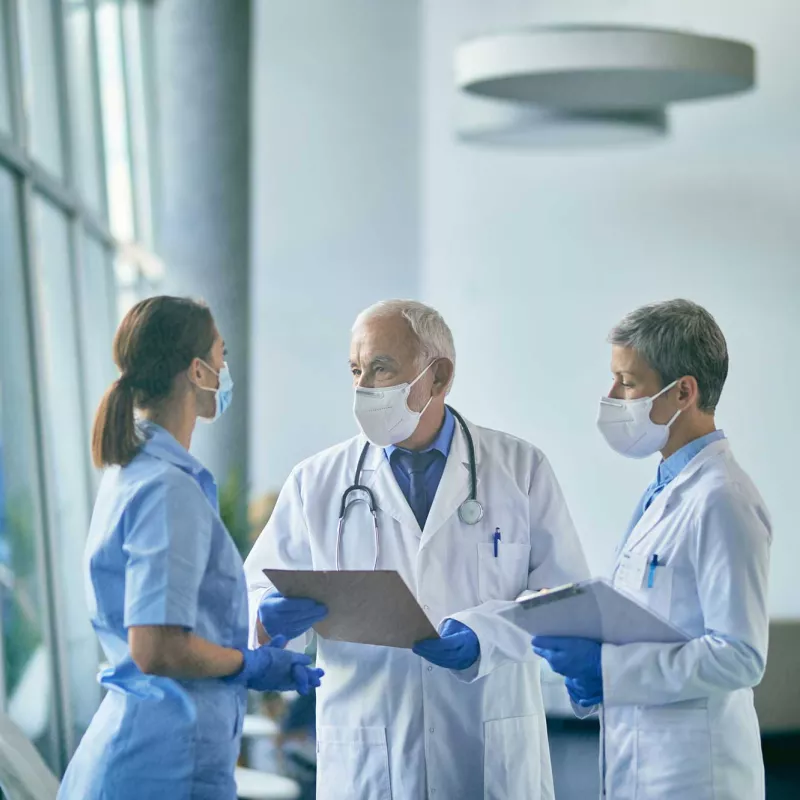 Two doctors and a nurse having a discussion