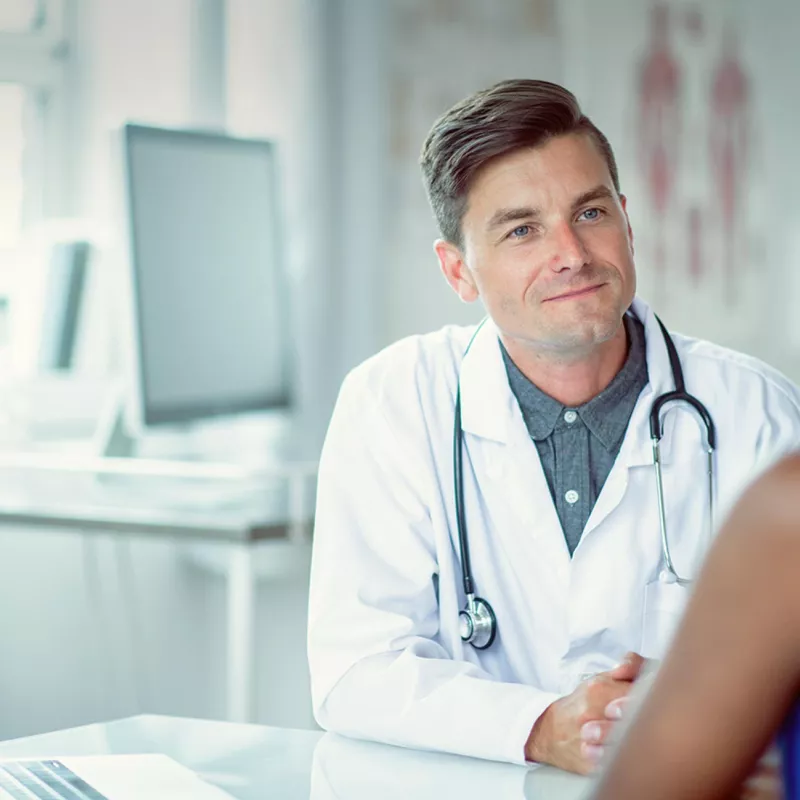 Doctor sitting at a table with a patient
