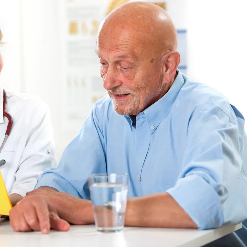 A man discusses his condition with his doctor.