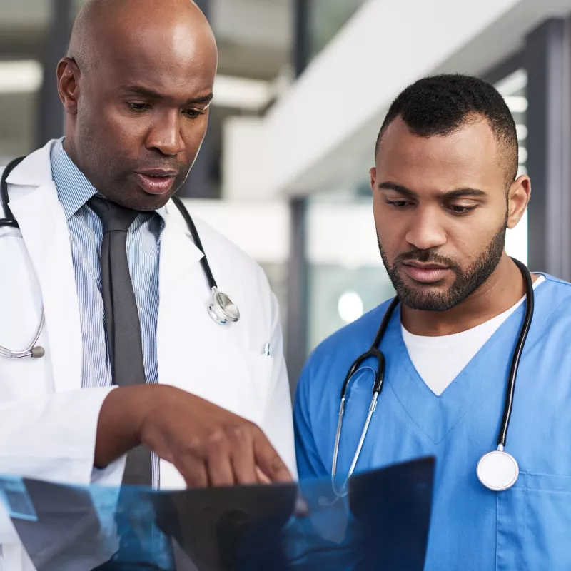 Two medical staff review an Xray.