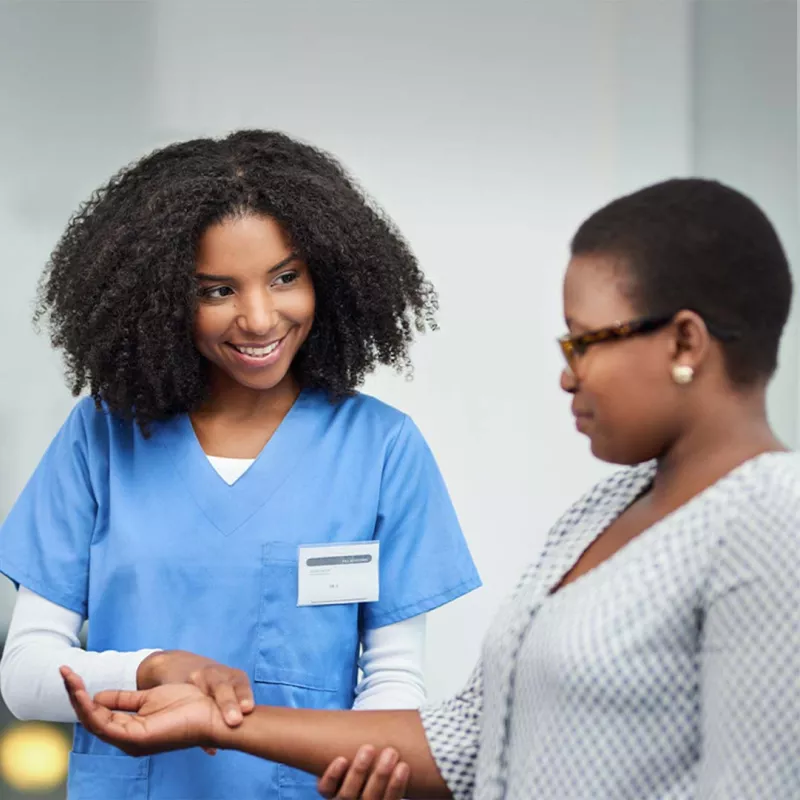 Nurse checking a patient's pulse