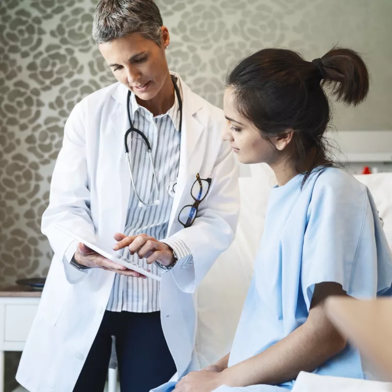 A woman reviews her test results with her doctor.