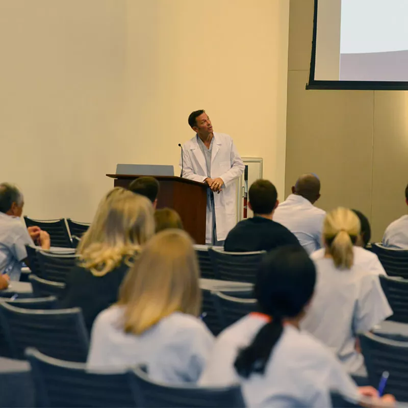 Man speaking at a conference.