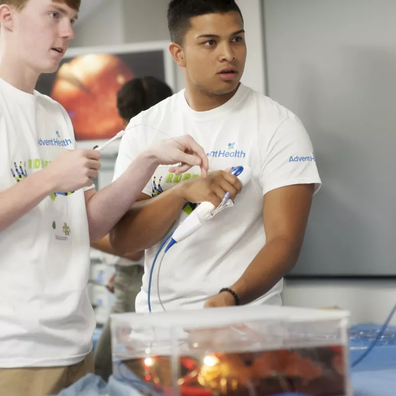 Two young men with AdventHealth shirts.