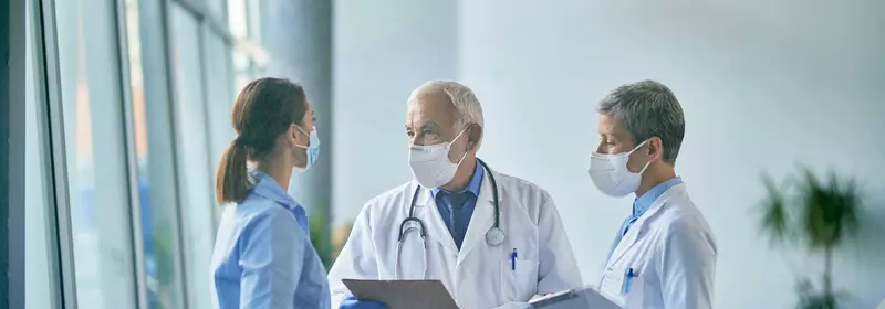 Two doctors and a nurse having a discussion