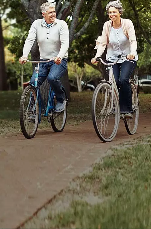 Old Couple Riding Bikes